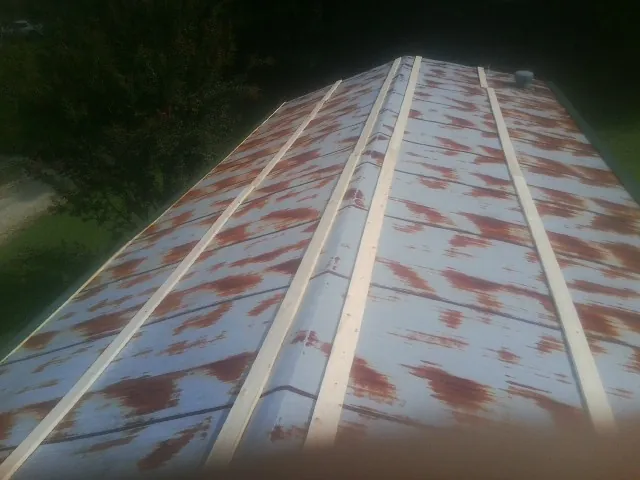 Rusted metal roof panels with new wood purlins before replacement — Storm Damage Roof Repair in Myersville by Roofing Brothers
