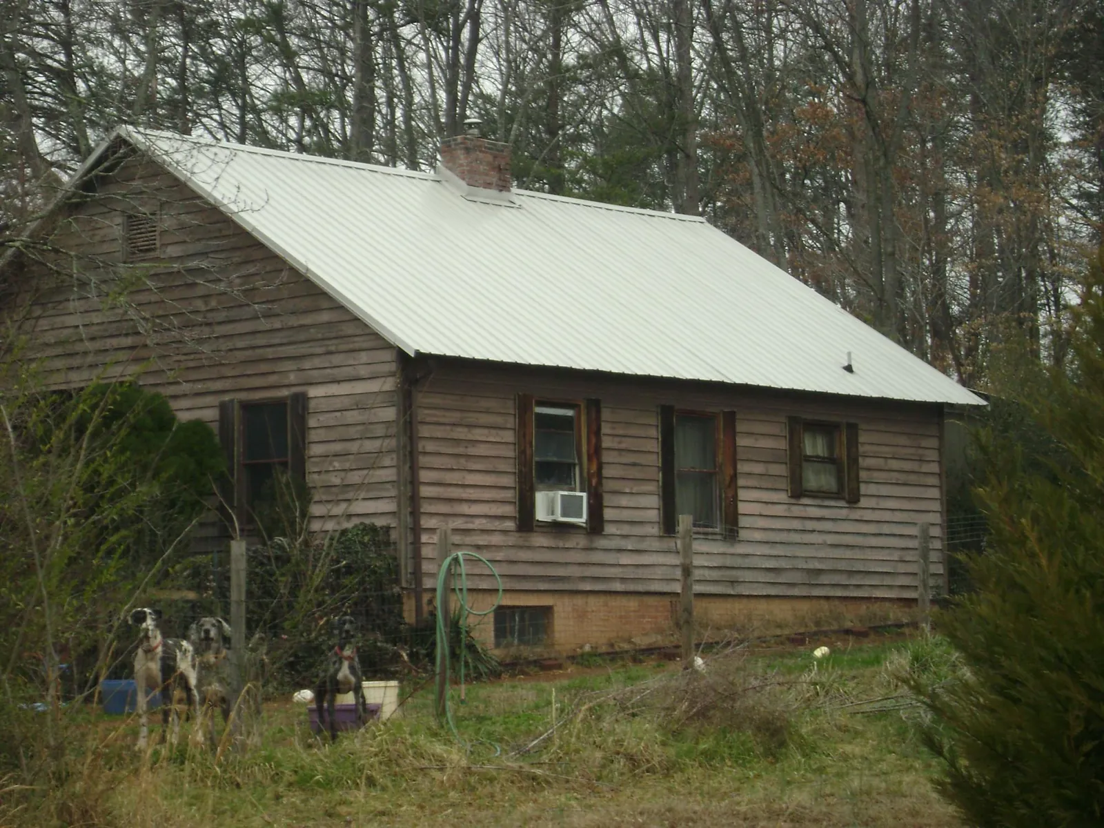 White metal roof on an old wood sided farmhouse, from a Metal Roof Installation job in Myersville